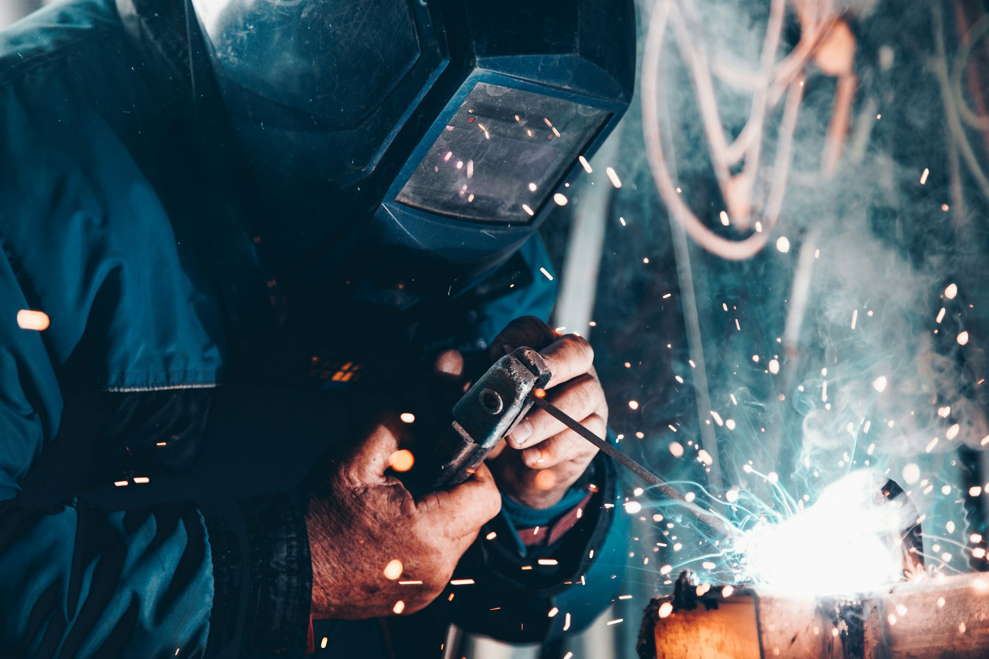 man-using-welding-machine.jpg man using welding machine